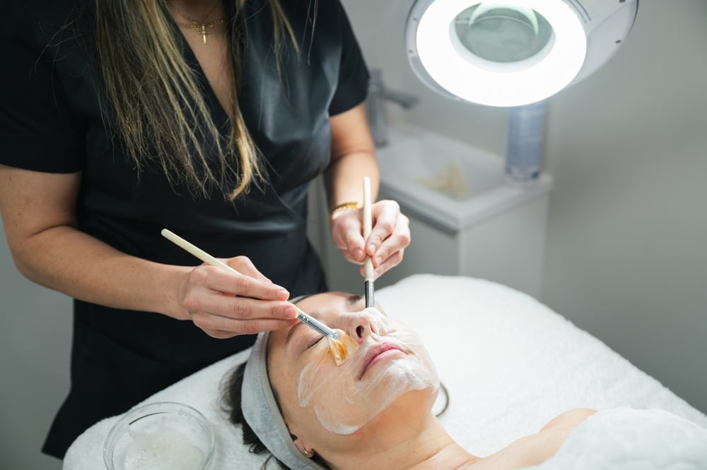Image of an exfoliant being applied on a woman's face